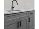 This wet bar has grey shaker cabinets, granite countertops, and a modern black faucet at 407 Estates View Dr, Acworth, GA 30101
