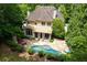 Aerial view of backyard featuring pool, patio, outdoor fireplace and lounge seating at 4101 Rickenbacker Ne Dr, Atlanta, GA 30342
