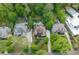 An aerial view showcases the neighborhood, the home, the in-ground pool, and the surrounding lush greenery at 4101 Rickenbacker Ne Dr, Atlanta, GA 30342