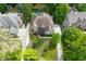 The perfectly manicured backyard, neighborhood, trees, and the home are captured from this aerial view at 4101 Rickenbacker Ne Dr, Atlanta, GA 30342