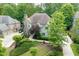 An aerial view showcases the neighborhood, the home, and the surrounding lush greenery at 4101 Rickenbacker Ne Dr, Atlanta, GA 30342