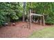 Backyard features swing set with hammocks and tables and chairs for adults at 4101 Rickenbacker Ne Dr, Atlanta, GA 30342
