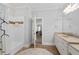 Bright bathroom showcasing a bathtub, white vanity with sink, and an open doorway to a sunlit living room at 4101 Rickenbacker Ne Dr, Atlanta, GA 30342