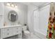 Well-lit bathroom features a vanity with storage, a toilet, and a tub with shower at 4101 Rickenbacker Ne Dr, Atlanta, GA 30342