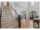 Entry foyer features staircase with iron spindles and view into dining and living rooms at 4101 Rickenbacker Ne Dr, Atlanta, GA 30342