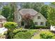 Charming two-story home with a stone chimney and a beautifully landscaped front yard at 4101 Rickenbacker Ne Dr, Atlanta, GA 30342