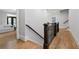 Upstairs hallway with hardwood floors and railing featuring wrought iron at 4101 Rickenbacker Ne Dr, Atlanta, GA 30342
