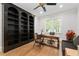 Home office features beautiful dark wood built-in bookcases and a large window at 4101 Rickenbacker Ne Dr, Atlanta, GA 30342