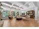 Open-concept living room with coffered ceilings, large windows, and a view of the kitchen at 4101 Rickenbacker Ne Dr, Atlanta, GA 30342