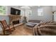 Inviting living room features a stone fireplace, hardwood floors, and bright natural light at 4101 Rickenbacker Ne Dr, Atlanta, GA 30342