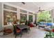 Covered patio features ceiling fan, comfortable seating, and dining area with backyard view at 4101 Rickenbacker Ne Dr, Atlanta, GA 30342