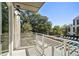 A balcony overlooks a pool and green trees on a sunny day at 775 Juniper Ne St # 334, Atlanta, GA 30308
