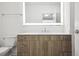 Modern bathroom features a lighted mirror and beautiful wood vanity at 775 Juniper Ne St # 334, Atlanta, GA 30308