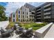 Modern apartment courtyard featuring lounge seating, green space, and architectural building exterior at 775 Juniper Ne St # 334, Atlanta, GA 30308