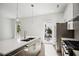 Bright kitchen with island and stainless steel appliances, opening to patio at 775 Juniper Ne St # 334, Atlanta, GA 30308
