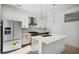 Open kitchen with stainless appliances, island, and designer finishes at 775 Juniper Ne St # 334, Atlanta, GA 30308