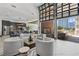Bright lounge with kitchenette, modern fireplace, patio and floor-to-ceiling windows providing city views at 775 Juniper Ne St # 334, Atlanta, GA 30308
