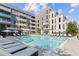 Resort-style pool surrounded by lounge chairs and umbrellas, perfect for relaxation and recreation at 775 Juniper Ne St # 334, Atlanta, GA 30308