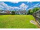 Large backyard with green lawn and a wood fence surrounding the perimeter at 1480 Holly Brook Rd, Snellville, GA 30078