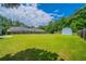 Expansive backyard with lush green grass, privacy fence, and storage shed at 1480 Holly Brook Rd, Snellville, GA 30078