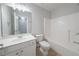 Well-lit bathroom featuring a single sink vanity and tub with tile flooring at 1480 Holly Brook Rd, Snellville, GA 30078