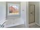 Bright bathroom featuring a soaking tub under a window and glass enclosed shower at 1480 Holly Brook Rd, Snellville, GA 30078