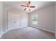 Bedroom with plush carpeting, ceiling fan, large closet and a window at 1480 Holly Brook Rd, Snellville, GA 30078