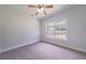 Bright bedroom with a ceiling fan and window overlooking the backyard at 1480 Holly Brook Rd, Snellville, GA 30078