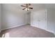 Cozy bedroom with neutral carpet, ceiling fan, and a closet at 1480 Holly Brook Rd, Snellville, GA 30078