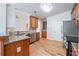 Well-lit kitchen featuring wood cabinets, granite countertops, and stainless steel appliances at 1480 Holly Brook Rd, Snellville, GA 30078