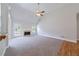 Open living room boasts vaulted ceiling, fireplace, and neutral carpet at 1480 Holly Brook Rd, Snellville, GA 30078