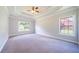 Spacious primary bedroom featuring a tray ceiling, soft carpet, and ample natural light at 1480 Holly Brook Rd, Snellville, GA 30078