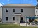 Backyard of home featuring neutral siding, stone and a patio at 1777 Weatherbrook Cir, Lawrenceville, GA 30043