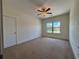 Bedroom with ceiling fan, large window and neutral color scheme at 1777 Weatherbrook Cir, Lawrenceville, GA 30043