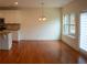 Bright dining area with hardwood floors, a modern chandelier, a large window, and a sliding glass door at 1777 Weatherbrook Cir, Lawrenceville, GA 30043