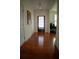 Inviting entryway featuring gleaming hardwood floors, a stylish light fixture, and a view of the front door with blinds at 1777 Weatherbrook Cir, Lawrenceville, GA 30043