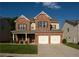Charming brick two-story home with a two-car garage and well-manicured front lawn, great curb appeal at 1777 Weatherbrook Cir, Lawrenceville, GA 30043