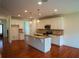 Modern kitchen with white cabinets, granite countertops, stainless steel appliances, hardwood flooring, and a center island at 1777 Weatherbrook Cir, Lawrenceville, GA 30043