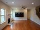 Spacious living room with hardwood floors, a fireplace, large windows, and a modern ceiling fan at 1777 Weatherbrook Cir, Lawrenceville, GA 30043