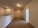Upstairs loft area with neutral carpet and natural light at 1777 Weatherbrook Cir, Lawrenceville, GA 30043
