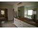 Main bathroom featuring double sinks, granite counters, soaking tub and tile flooring at 1777 Weatherbrook Cir, Lawrenceville, GA 30043