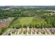 Aerial view showcases a neighborhood with lush greenery and a home with a well-kept lawn in a scenic area at 3365 Buffington Ln, Cumming, GA 30040