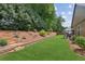 Backyard featuring a retaining wall, patio, and landscaped garden at 3365 Buffington Ln, Cumming, GA 30040