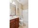 Bathroom featuring a vanity with cherry cabinets, a toilet, and a bathtub with a shower at 3365 Buffington Ln, Cumming, GA 30040