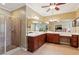Primary bathroom with double vanity, walk-in shower, and tile flooring at 3365 Buffington Ln, Cumming, GA 30040