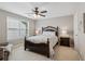 Cozy bedroom featuring a plush bed, neutral walls, ample natural light, and a ceiling fan at 3365 Buffington Ln, Cumming, GA 30040