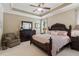 Primary bedroom with trey ceiling, dark wood furniture set and plush carpeting at 3365 Buffington Ln, Cumming, GA 30040