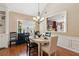 Bright dining room with hardwood floors, elegant chandelier, and access to the kitchen at 3365 Buffington Ln, Cumming, GA 30040