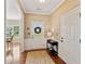 Inviting entryway with hardwood floors, a decorative rug, and a view into the dining area at 3365 Buffington Ln, Cumming, GA 30040
