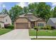 Charming home showcasing a well-manicured lawn, neutral siding, and a convenient two-car garage at 3365 Buffington Ln, Cumming, GA 30040